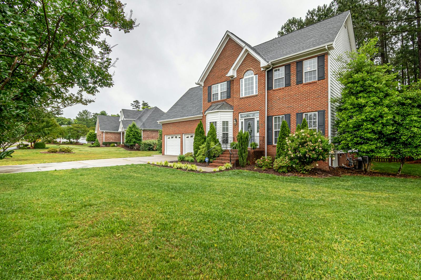 Two-story brick house with a wide lawn